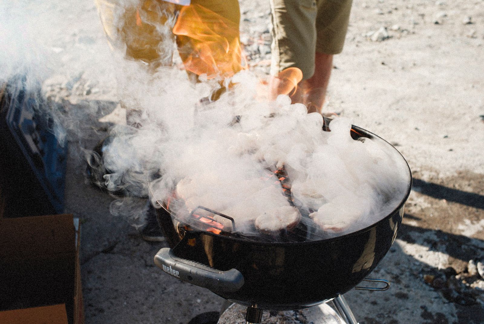 Smoke rising from a barbecue pit outdoors