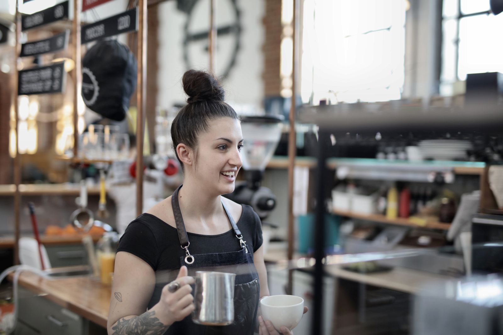 A barista preparing coffee at a busy cafe counter