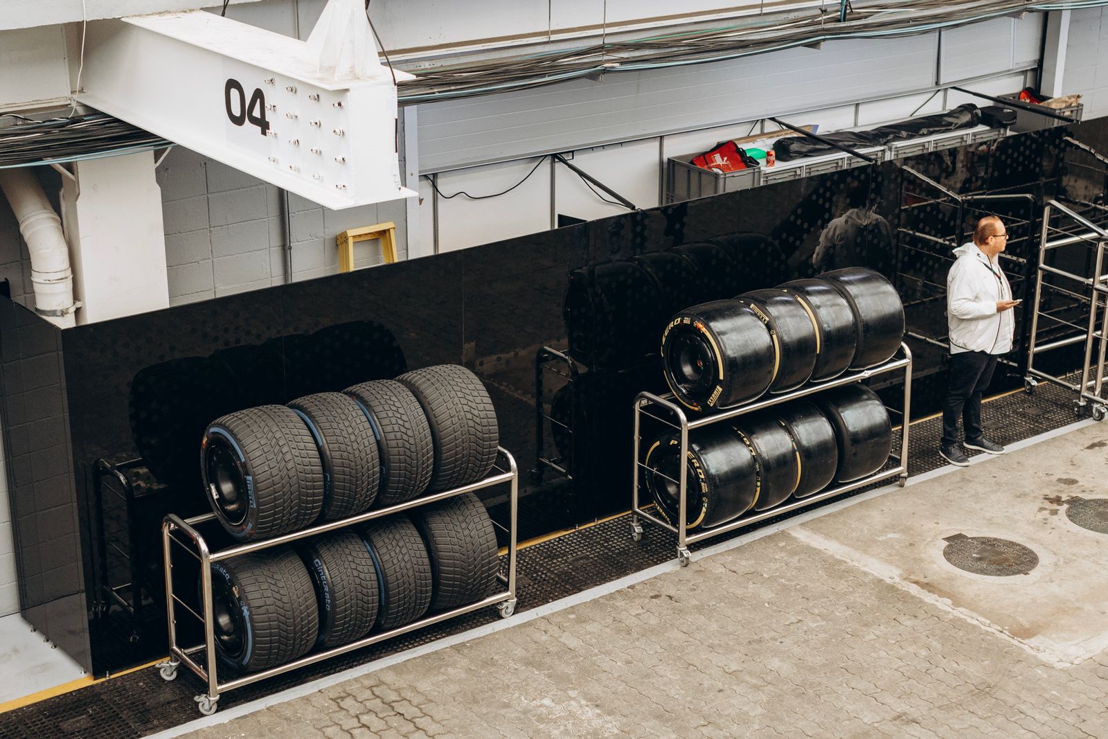Tires stored on racks along a workshop wall