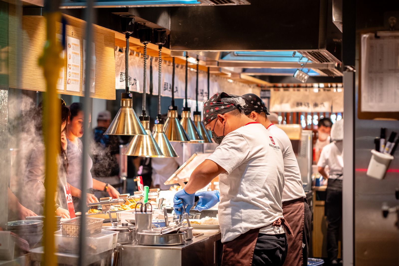 Cooks working the line in a busy restaurant kitchen