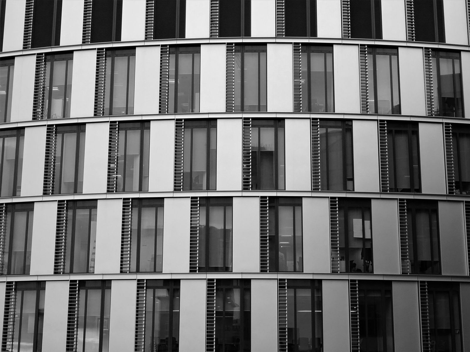 Black and white facade of an office building with rows of windows