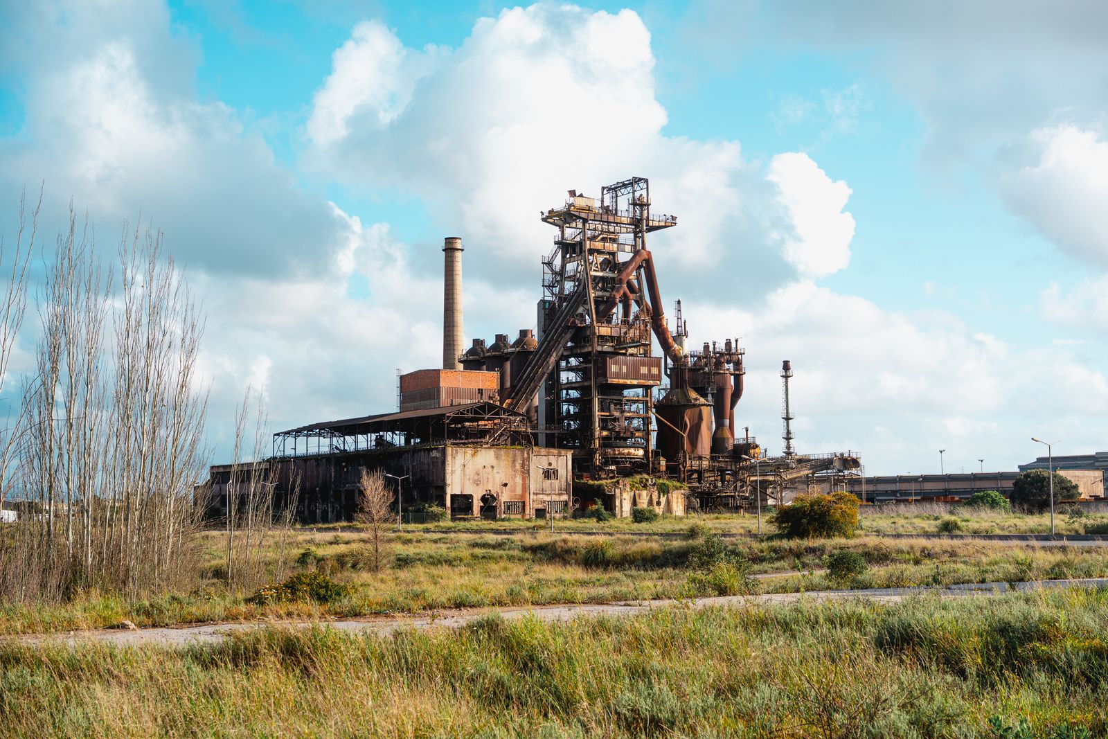 An old industrial works standing in rough grassland