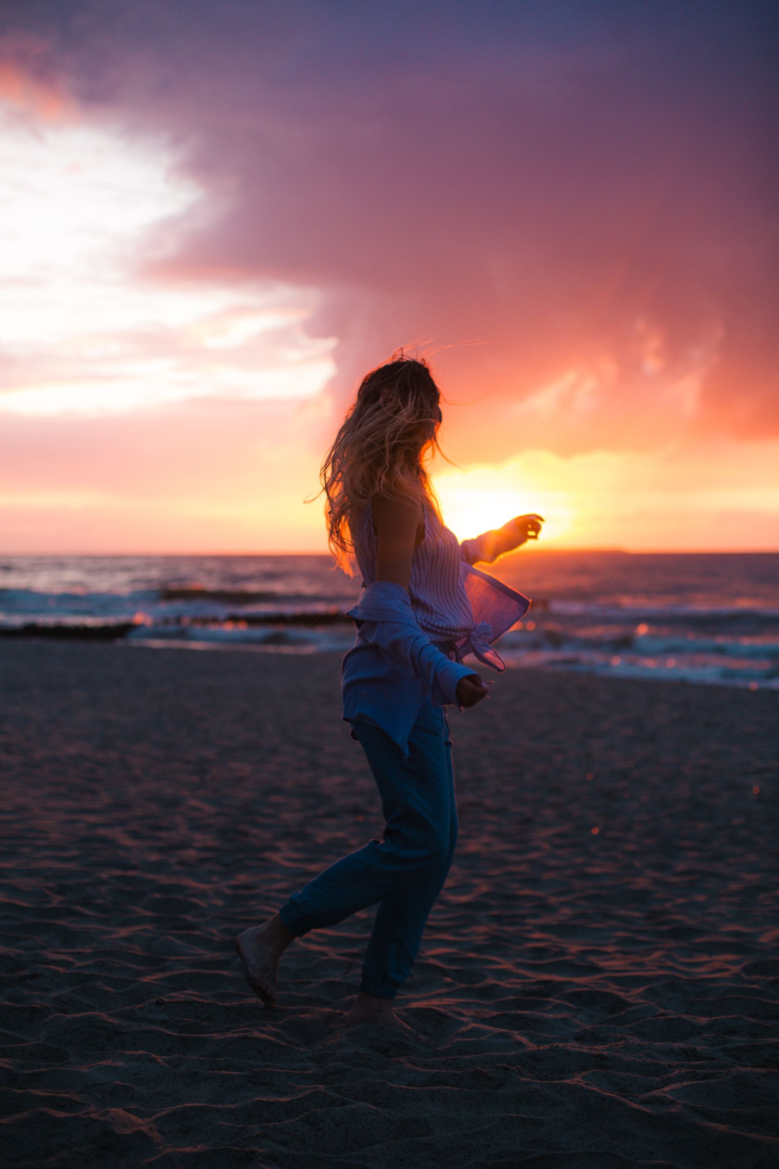 The same beach photo after the edit: warm sky, lifted faces and deep shadows in the sand
