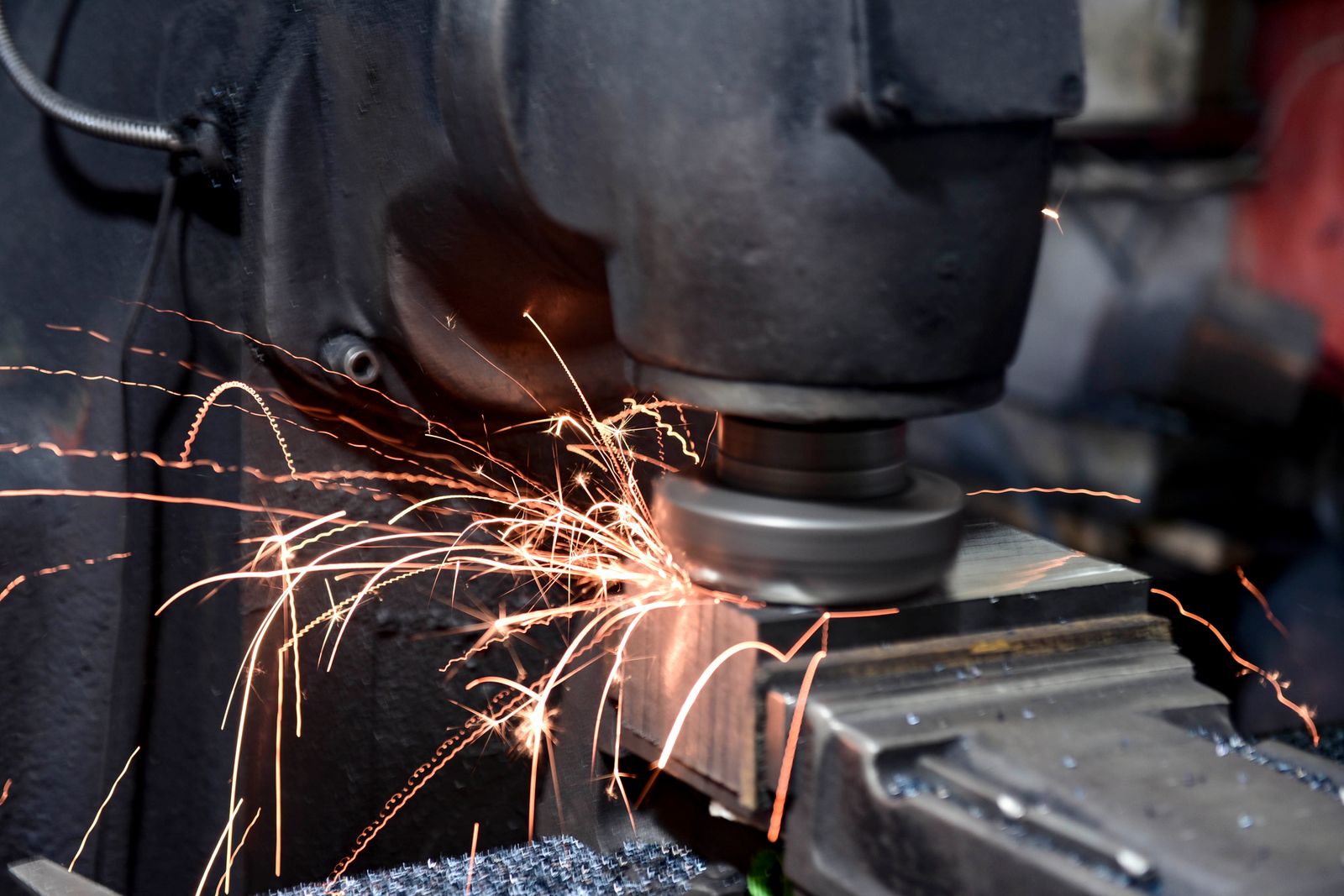 Grinding wheel throwing sparks off a steel part