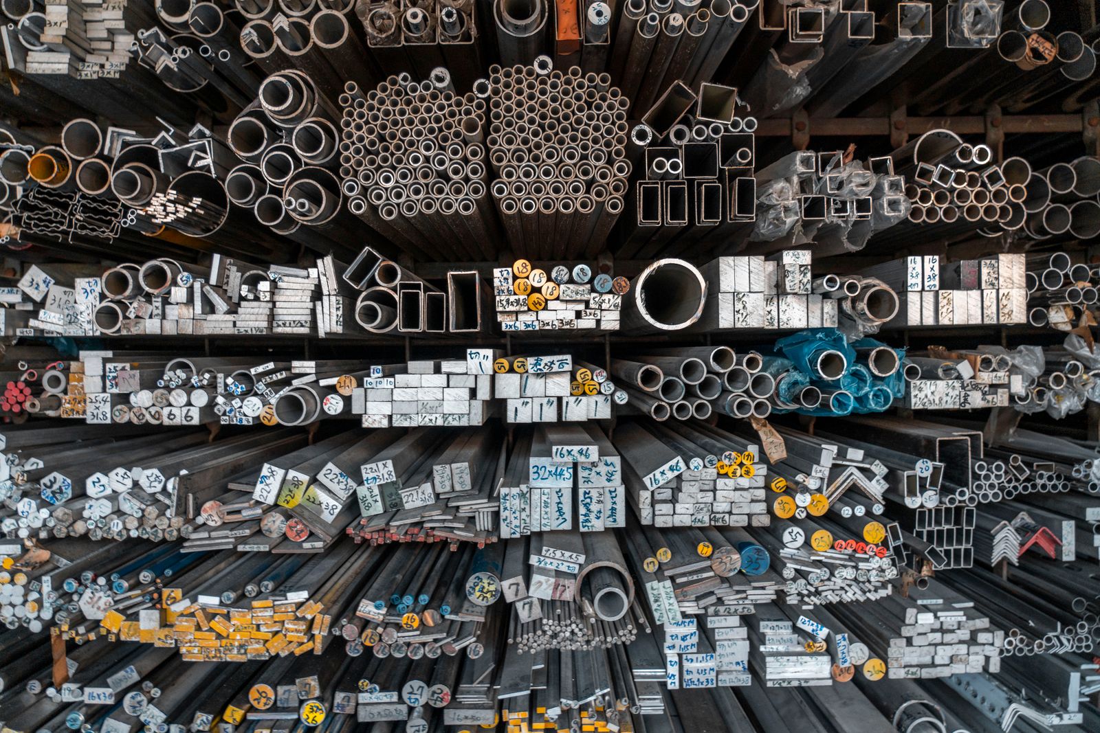 Racks of metal bars, tubes and profiles in a stockholder's warehouse