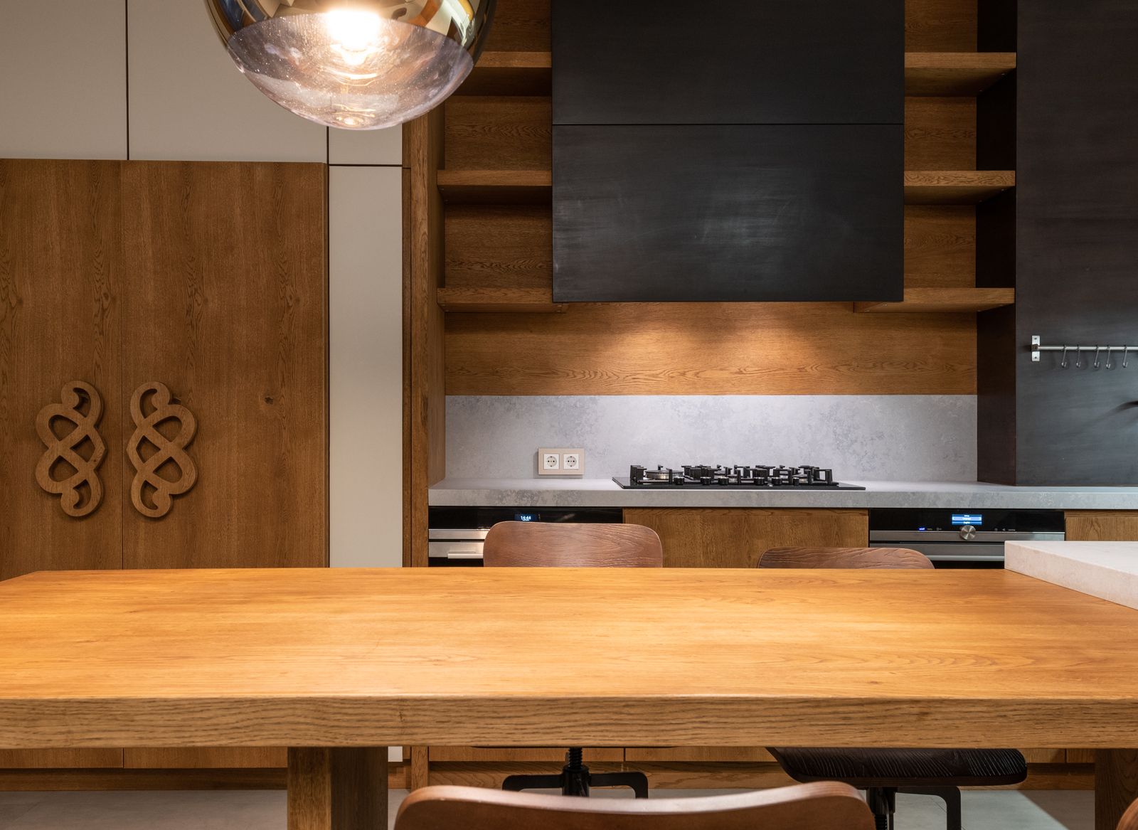 Oak kitchen worktop and cabinets with a stove and simple shelves