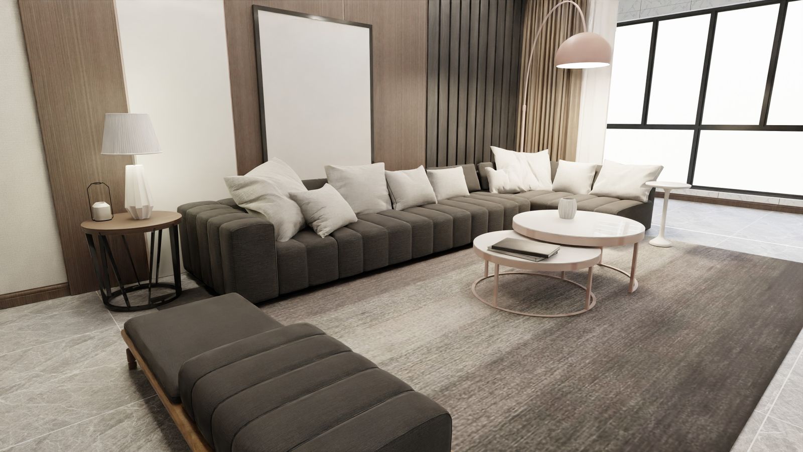 A calm living room with a long grey sofa, a round coffee table and a low upholstered bench by tall windows