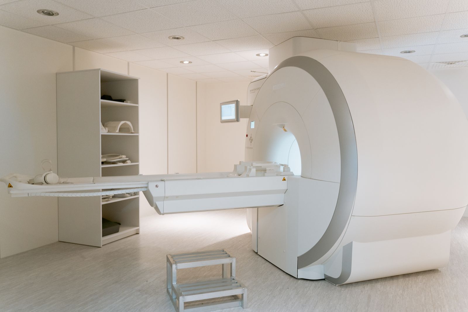 An empty MRI scanner room with the table ready