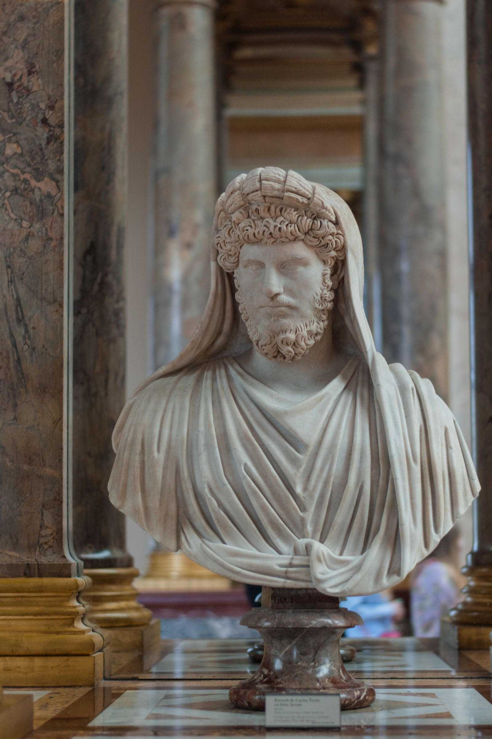 Marble portrait bust of a bearded man in a draped cloak