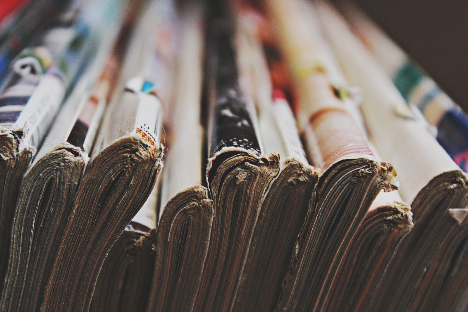 A long row of printed magazines seen from their spines