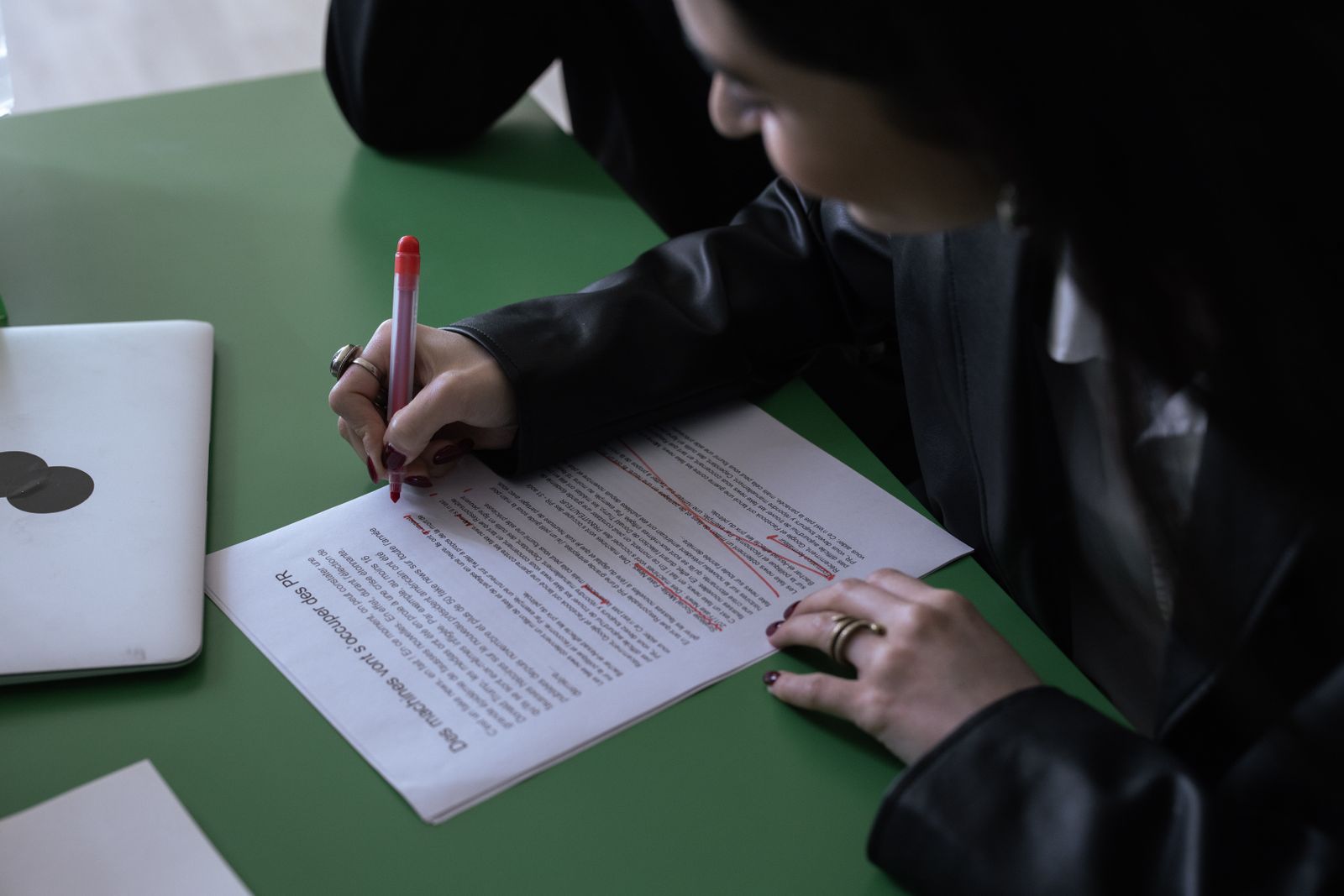 Marking up a printed draft with a red pen