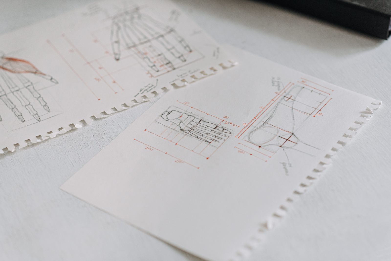 Technical drawings of a product laid out on white paper sheets