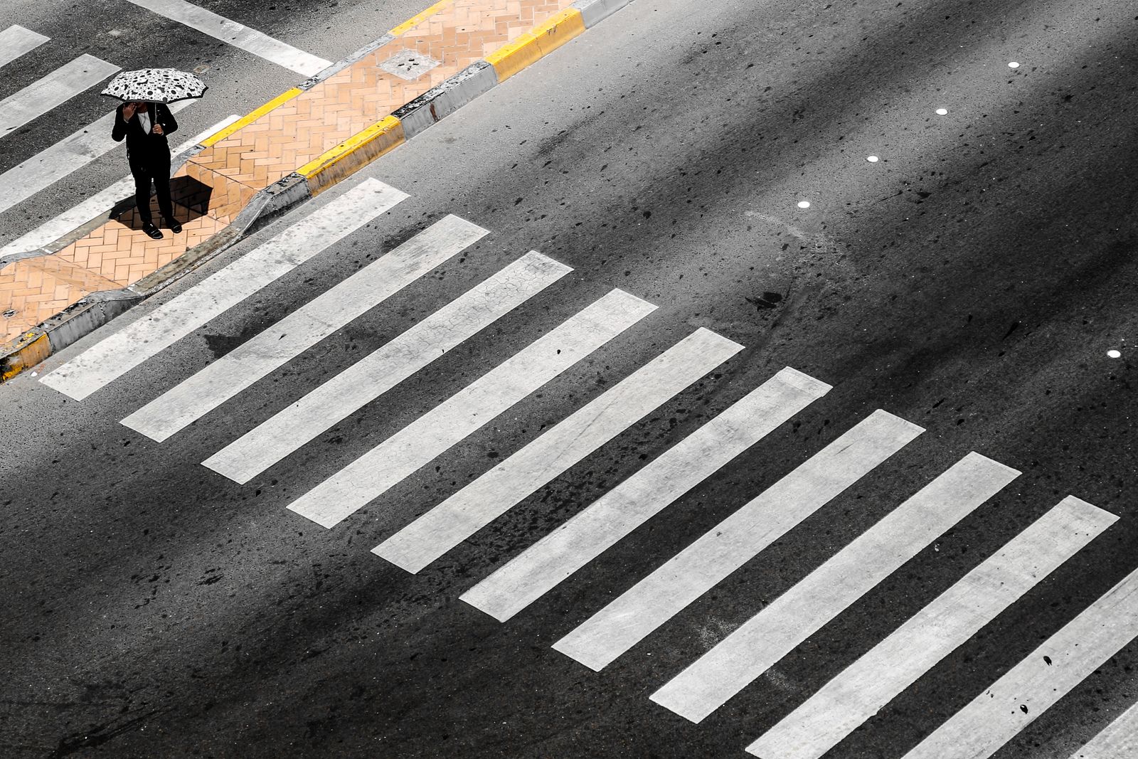 A pedestrian on a zebra crossing, seen from above