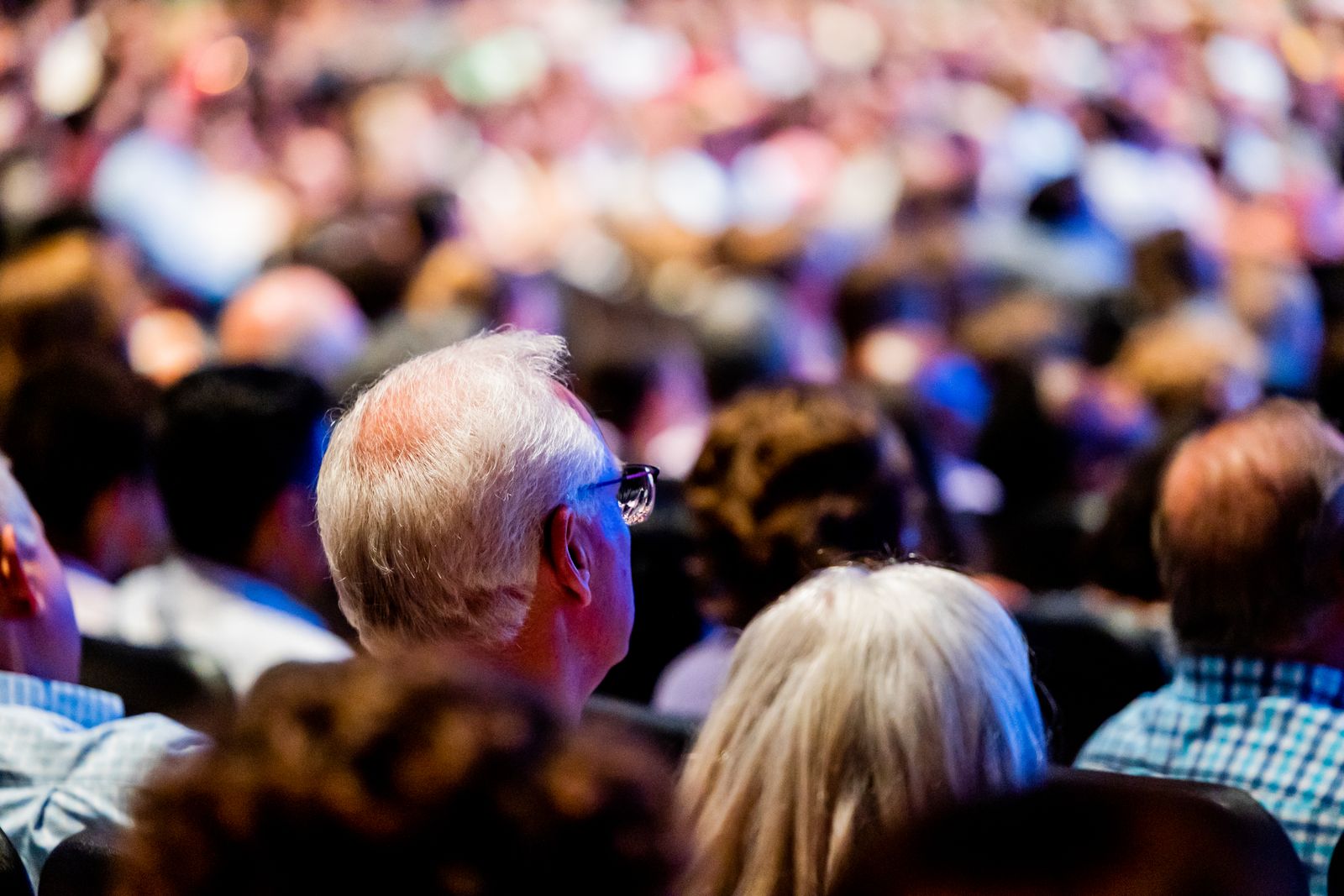 Residents seen from behind, listening at a community meeting