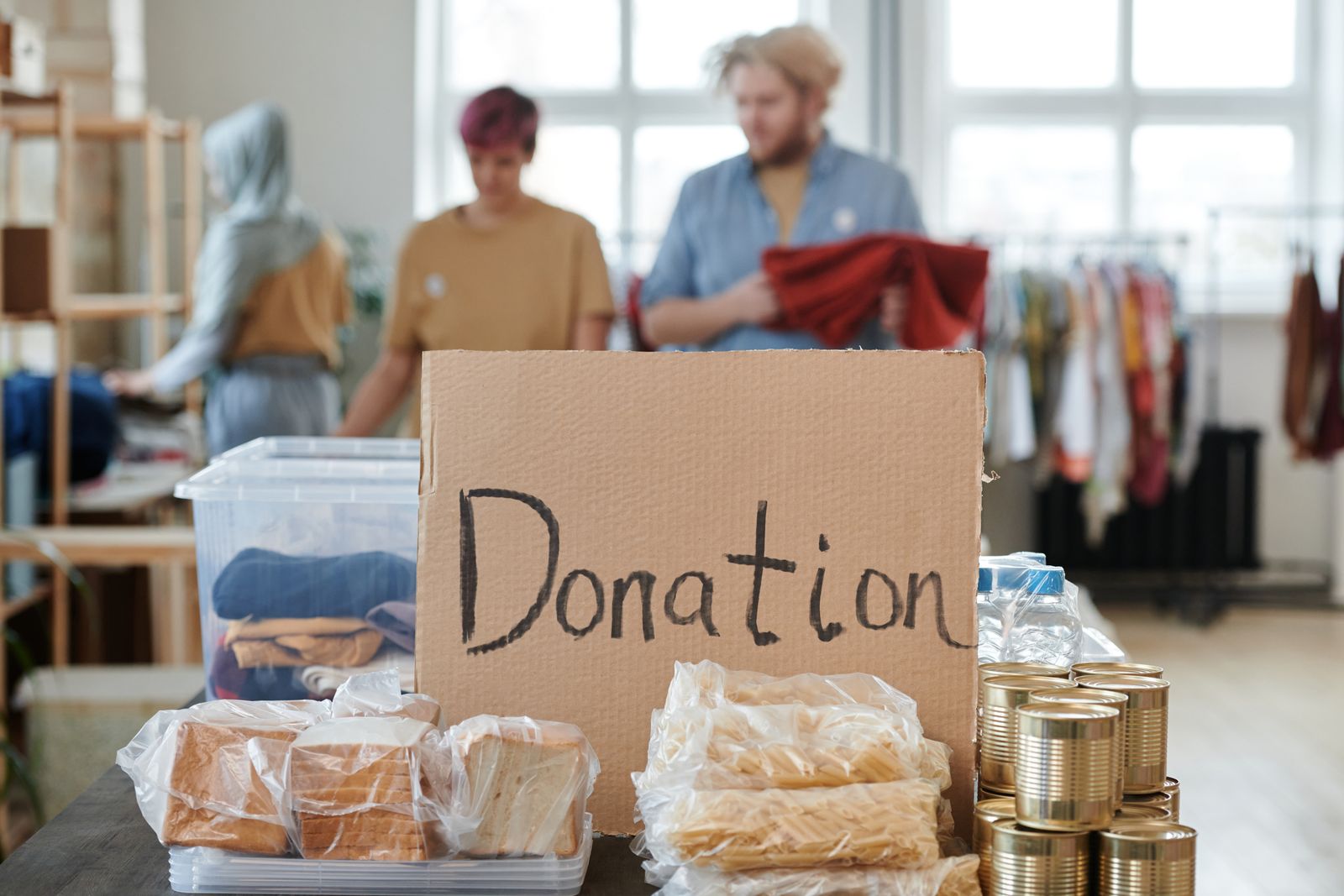 A food bank table with bread, tinned food and a handwritten Donation sign