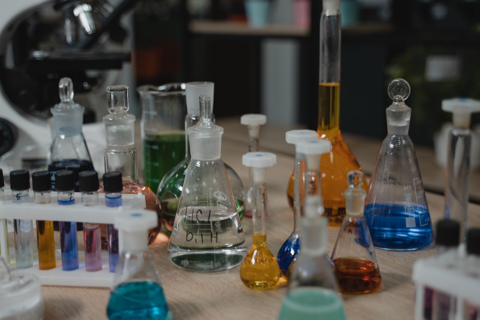 Coloured liquids in flasks and beakers on a lab bench