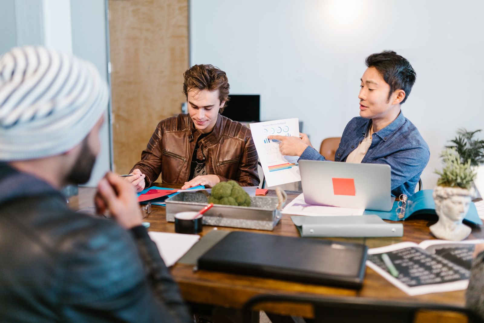 Colleagues discussing project notes in a modern office