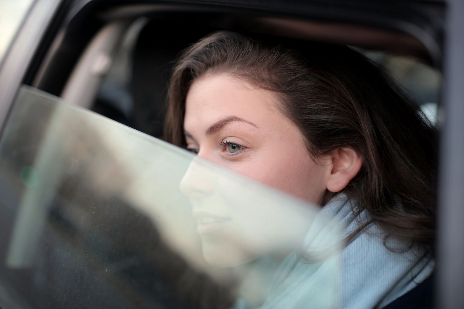 A passenger looking out of a car window